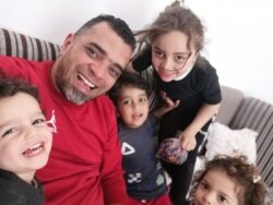 Wasef Gelani and his four children fled their home a year ago, and now they remain in a rented apartment hearing bombings everyday, March 23, 2020.