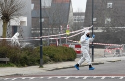 Forensic officers investigate the area at the scene of an explosion at a coronavirus testing location in Bovenkarspel, near Amsterdam, Netherlands, March 3, 2021.