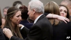 Michigan State University Department of Police and Public Safety Chief and Director Jim Dunlap, right, comforts Kyle Stephens, an abuse victim, after a sentencing hearing for Larry Nassar, Jan. 24, 2018, in Lansing, Michigan. 