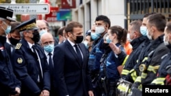 French President Emmanuel Macron visits the scene of a knife attack at Notre Dame church in Nice, France, Oct. 29, 2020.