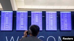 Passengers wait for the flights to resume at Hartsfield-Jackson Atlanta International Airport in Atlanta