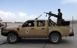 FILE - Afghan army soldiers patrol after the American military left Bagram air base, in Parwan province north of Kabul, Afghanistan, July 5, 2021.