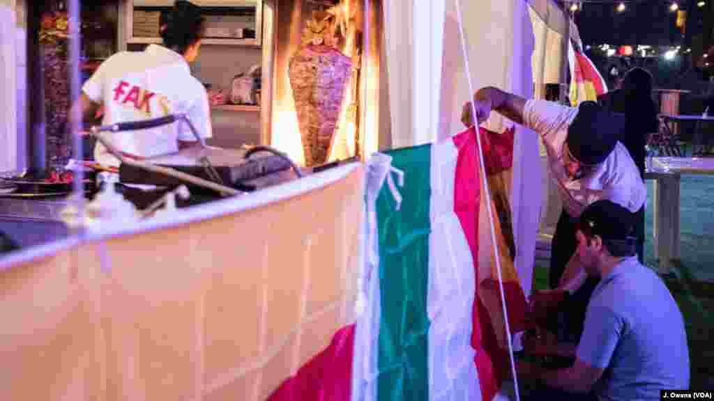 Outside the dome, where a souk sells a range of food, flags backing various teams are put up.