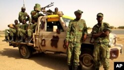 Soldiers from Burkina Faso stand guard at the airport, in Timbuktu, Mali, May 22, 2013.