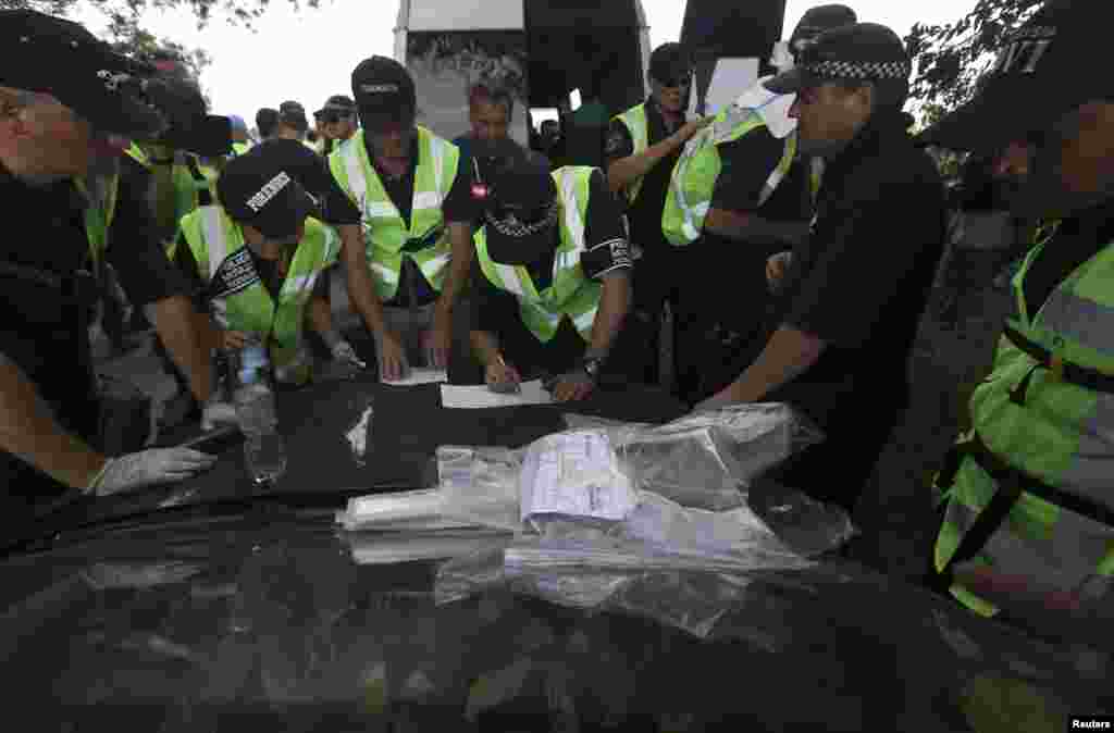 Dutch and Australian forensic experts continue recovery work at the site of the downed Malaysian airliner MH17 near the village of Rozsypne, in the Donetsk region, Aug. 4, 2014.
