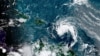 This satellite image provided by the National Oceanic and Atmospheric Administration shows a tropical storm east of Puerto Rico in the Caribbean, at 7:50 a.m. EST, Aug. 10, 2021.