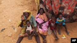 Photo released by the United Nations African Union Mission in Darfur (UNAMID) shows women and their children outside their tents at the Zam Zam refugee camp for internally displaced people (IDP) in North Darfur, Sudan, June 11, 2014.