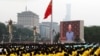 Chinese President Xi Jinping, center, waves above a large portrait of the late leader Mao Zedong during a ceremony to mark the 100th anniversary of the founding of the ruling Chinese Communist Party at Tiananmen Gate in Beijing, July 1, 2021. 