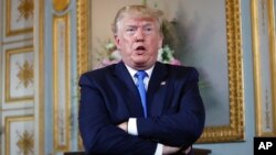 FILE - President Donald Trump speaks during a meeting with French President Emmanuel Macron in Caen, France, June 6, 2019.