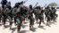 FILE - Al-Shabab fighters march during military exercises in the Lafofe area, 18 kilometers south of Mogadishu, Somalia, Feb. 17, 2011.