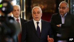 Perdana Menteri Irak Haider al-Abadi (tengah) dalam konferensi pers sebelum pergi ke AS di bandara Baghdad, Irak (13/4). (AP/Khalid Mohammed)