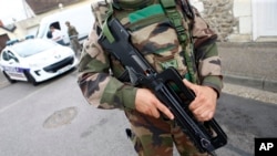 A French soldier stands guard while preventing the access to the scene of an attack in Saint-Etienne-du-Rouvray, Normandy, France, July 26, 2016.