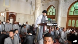 Radical Shiite cleric Muqtada al-Sadr is surrounded by bodyguards as he speaks at Friday prayers in Kufa, Iraq (File Photo)