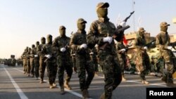 Members of Iraqi Popular Mobilization Forces take part in a military parade in the town of Taza, south of the northern oil city of Kirkuk, Iraq, June 28, 2019.