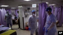Palestinian doctors treat patients at the emergency room of the al-Quds Hospital in Gaza City, Sept. 7, 2020.