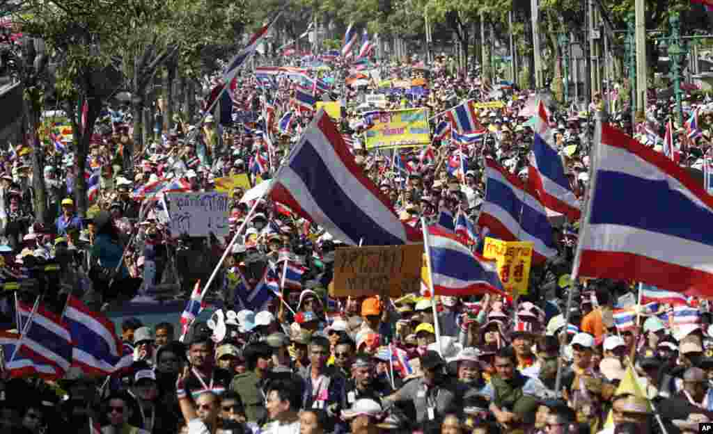 Thai anti-government protesters march in the streets, Dec. 22, 2013, in Bangkok, Thailand.&nbsp;