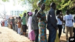 People wait to vote outside a polling station in Serrekunda, southwest the capital Banjul, during the presidential elections, November 24, 2011.