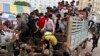 Cambodian migrant workers get off from a Thai truck upon their arrival from Thailand at a Cambodia-Thai international border gate in Poipet, Cambodia, Tuesday, June 17, 2014. The number of Cambodians who have returned home from Thailand this month after a threatened crackdown on foreigners working illegally has topped 160,000, a Cambodian official said Monday. Thai officials insist the cross-border movement is voluntary and is not forced repatriation. They say Thai military and government resources were used to transport workers who decided to return home after being laid off because they were working illegally. (AP Photo/Heng Sinith)