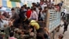 Cambodian migrant workers get off from a Thai truck upon their arrival from Thailand at a Cambodia-Thai international border gate in Poipet, Cambodia, Tuesday, June 17, 2014. 