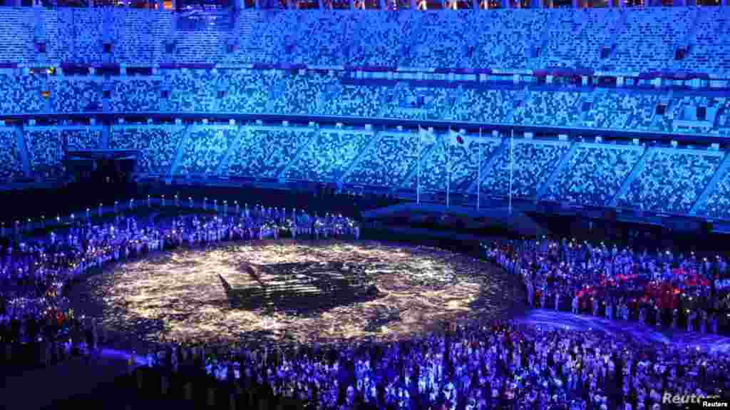 The Olympic Stadium is lighted up as athletes take part in the athletes&#39; parade during the closing ceremony, Aug. 8, 2021.