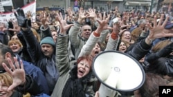 July 23: A woman holds her child at a ocal hospital where children receive treatment for malnutrition at the border town of Dadaab, Kenya. The drought in the Horn of Africa and the famine in Somalia has left more than two million children at risk of star