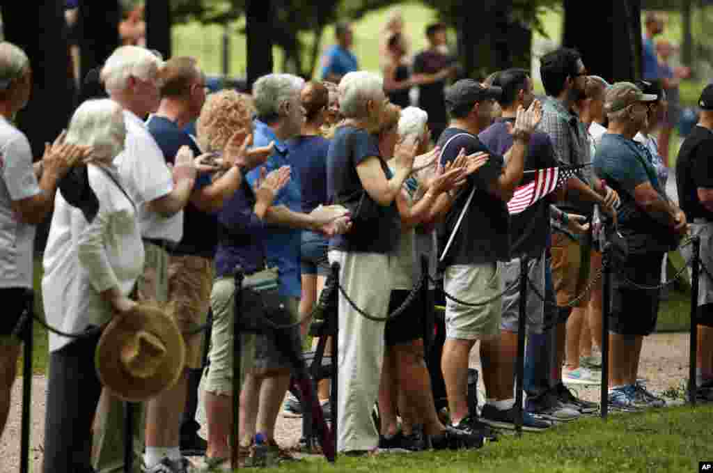 Onlookers applaud as Cindy McCain, wife of Sen. John McCain, and other family members depart after placing a wreath at the Vietnam Veterans Memorial, Sept. 1, 2018, in Washington.