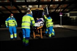 Madrid's Emergency Service UVI-8 unit's members push a stretcher with a patient at Clinico San Carlos hospital amid the coronavirus outbreak in Madrid, Spain, Oct. 19, 2020. (Reuters)