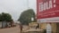 FILE - A billboard with an Ebola message looms over a street in Conakry, Guinea, Oct. 26, 2014.