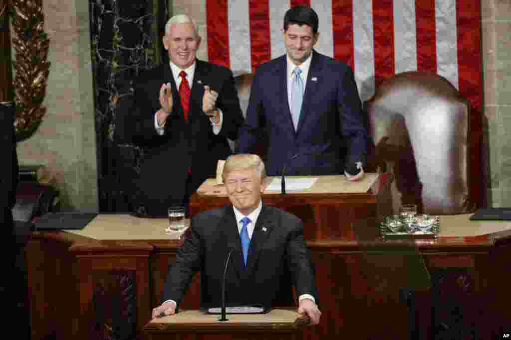 President Donald Trump steps to the podium to begin his State of the Union address to a joint session of Congress on Capitol Hill in Washington, Jan. 30, 2018. Behind Trump are Vice President Mike Pence and House Speaker Paul Ryan of Wisconsin. 