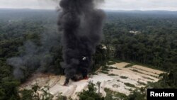 FILE - Machines are destroyed at an illegal gold mine during an operation conducted by agents of the Brazilian Institute for the Environment and Renewable Natural Resources, in national parks near Novo Progresso, Brazil, Nov. 5, 2018. 
