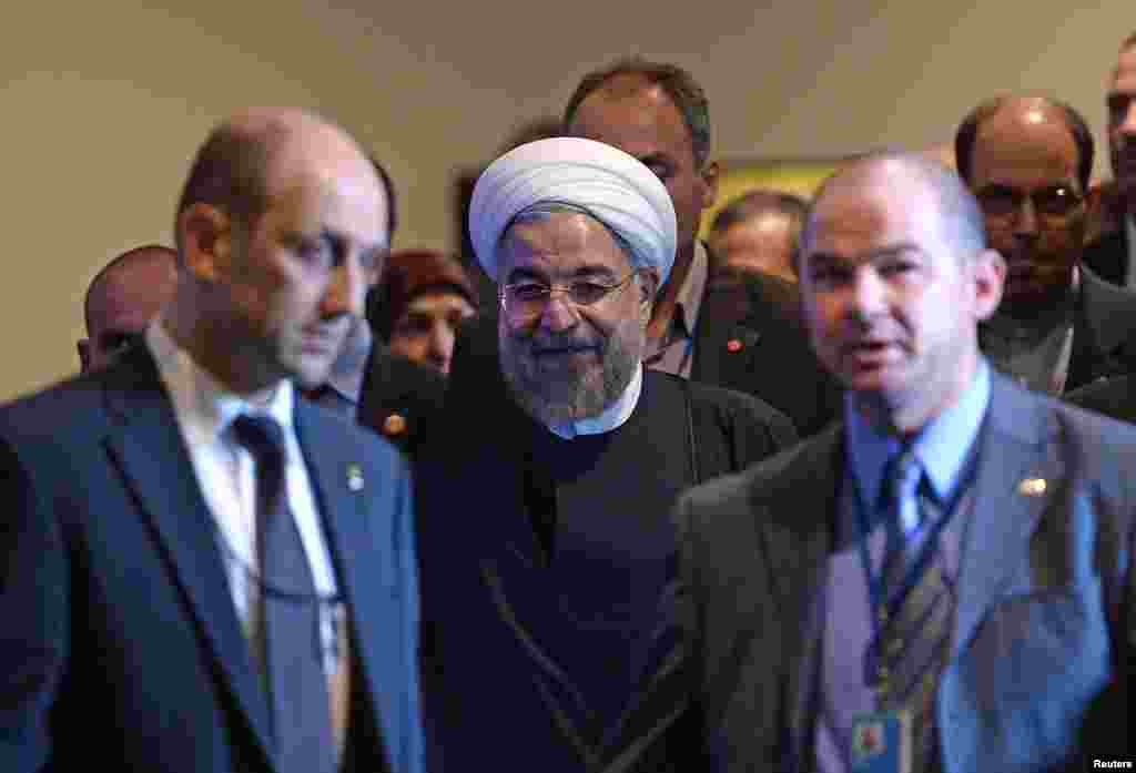 Iran&#39;s President Hassan Rouhani (center) is escorted for a meeting with U.N. Secretary-General Ban Ki-moon on the sidelines of the U.N. General Assembly in New York, Sept. 23, 2014. 