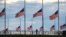 A jogger passes flags flying at half-staff at the Washington Monument on the National Mall following the death of former U.S. President Jimmy Carter, in Washington, Dec. 30, 2024. 