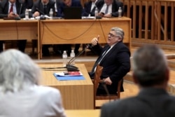 FILE - Leader of Greece's far-right Golden Dawn party Nikos Mihaloliakos testifies during the trial of members and leaders of the party in a Court in Athens, Greece, Nov. 6, 2019.