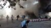 People react as a building burns after fresh protests broke out in Wamena, Indonesia's restive Papua region, Sept. 23, 2019.