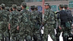Armed police officers patrol an ethnice Uighur area in Kashgar, in Xinjiang province Aug. 4, 2011.
