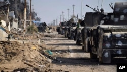 Iraqi security forces surround the government complex in central Ramadi, 70 miles (115 kilometers) west of Baghdad, Iraq, Monday, Dec. 28, 2015. (AP Photo)