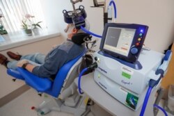 FILE - A patient receives a transcranial magnetic stimulation treatment for depression at the VA Palo Alto Health Care System, Nov. 7, 2018, Palo Alto, Calif.