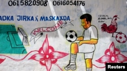 FILE - A mural depicting a soccer player is seen on a wall of a stadium in Hodan district of Mogadishu, Somalia, June 13, 2017. 