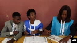 Voting officials are seen at their stations during a presidential election in Luanda, Angola, Aug. 23, 2017.