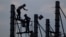 FILE - Workers on scaffolding are silhouetted at a construction site near Phnom Penh, Cambodia.
