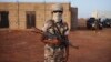 An ethnic Tuareg Malian soldier under the command of Col. El Hadj Ag Gamou stands guard at a checkpoint in Gao, Mali, March 3, 2013.