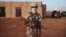 An ethnic Tuareg Malian soldier under the command of Col. El Hadj Ag Gamou stands guard at a checkpoint in Gao, Mali, March 3, 2013.