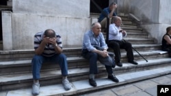 Elderly people, who usually get their pensions at the end of the month, wait outside a closed bank in the northern Greek port city of Thessaloniki, June 29, 2015.