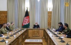 FILE - Gen. Mark Milley, chairman of the U.S. Joint Chiefs of Staff, meets with President Ashraf Ghani to discuss peace efforts and the security environment in Afghanistan, Dec. 17, 2020.