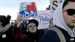 FILE - Protesters march in Chicago before a rally with Republican presidential candidate Donald Trump at the University of Illinois-Chicago, March 11, 2016. Trump's strong language throughout his campaign has drawn in some supporters perceived as hate-filled extremists.
