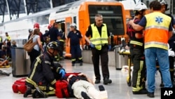 An injured passenger is attended to on the platform of a train station in Barcelona, Spain, July 28, 2017. 