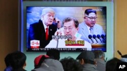 FILE - People watch a TV screen showing images of North Korean leader Kim Jong Un, right, South Korean President Moon Jae-in, center, and U.S. President Donald Trump at the Seoul Railway Station in Seoul, South Korea, March 7, 2018.