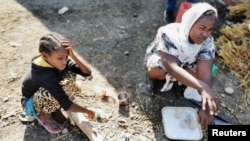 Ethiopian children, who fled the ongoing fighting in Tigray region, are seen at the al-Fashqa refugee camp in the Sudan-Ethiopia border town of al-Fashqa, in eastern Kassala state, Sudan, Nov. 13, 2020.