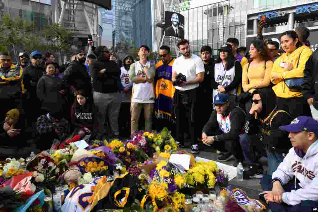 People gather at a memorial for Kobe Bryant near Staples Center, Jan. 26, 2020, in Los Angeles.