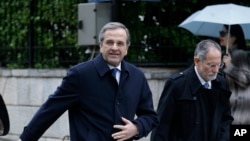 Greece's Prime Minister Antonis Samaras leaves his office for a meeting with Greek President Karolos Papoulias in Athens, Tuesday, Dec. 30, 2014.